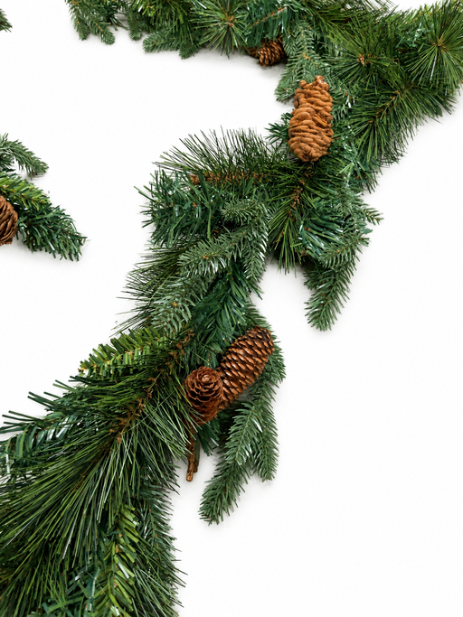 Close-up of Christmas garland needles and brown pine cones on white background