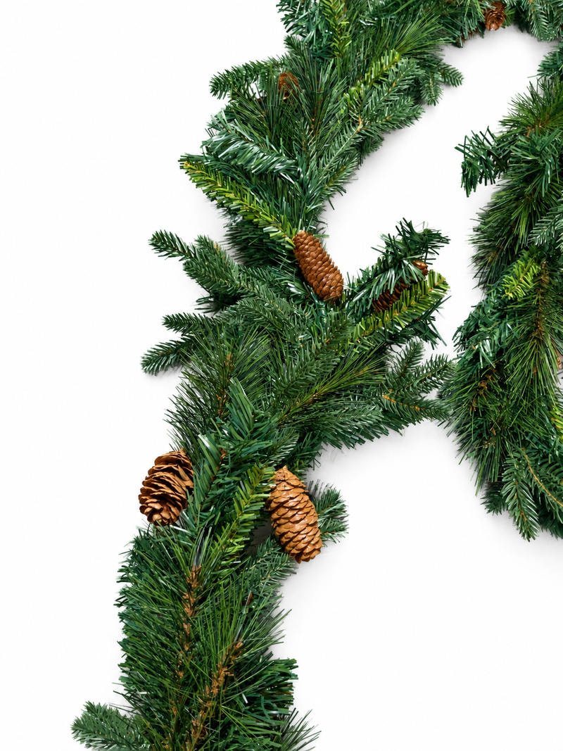 Close-up of Christmas garland needles and brown pine cones on white background