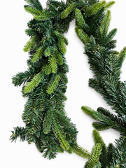 Close-up of mixed green needles on Christmas garland